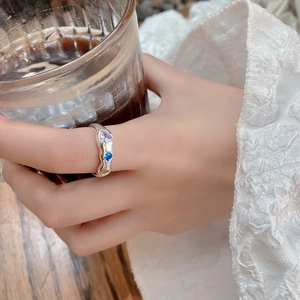Detailed view of S925 silver wave ring with colorful heart gemstones on finger