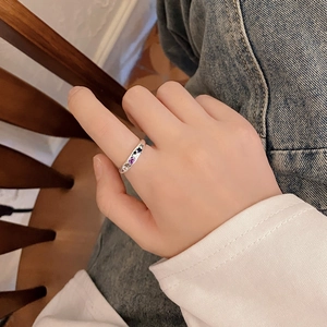Close-up of S925 silver ring with purple zircon and moon star engraving on finger