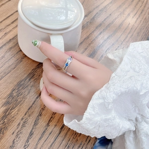 Irregular S925 silver ring with blue and purple zircon stones on a model hand