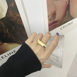 Minimalist 925 silver style gold polished streamline ring worn by a model