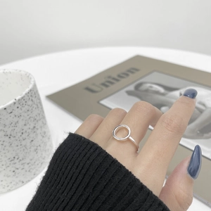 Close-up of minimalist S925 sterling silver hollow round open ring on finger