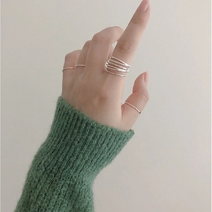 Close-up of S925 sterling silver multi-layer intertwined ring with minimalist thin bands