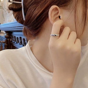 Detailed shot of an S925 sterling silver ring with purple zircon and black star motifs