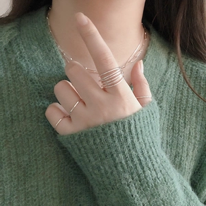 Close-up of minimalist S925 sterling silver multilayer intertwined rings on a model