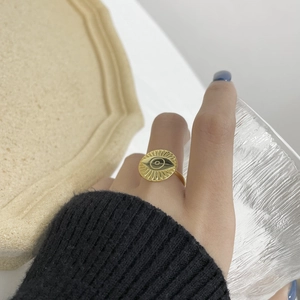 Macro detail of vintage gold Evil Eye signet ring featuring intricate sunburst engraving