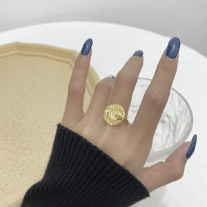 Retro S925 silver Evil Eye gold ring with sunburst engraving on a female hand
