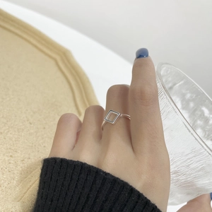 Minimalist S925 sterling silver square geometric ring worn on hand holding a glass