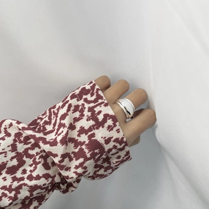 Close-up of polished S925 sterling silver wide band ring with a reflective mirror finish