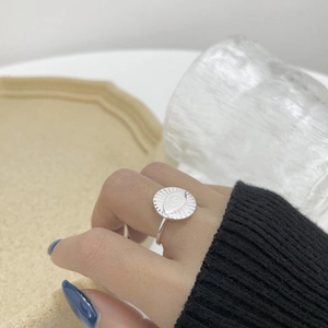 Macro shot of S925 sterling silver evil eye ring on hand with sunburst coin design