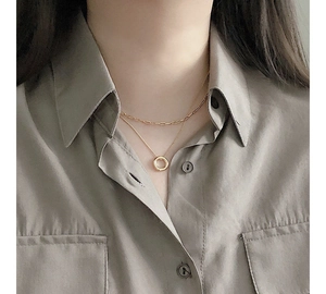 Minimalist double layer gold necklace featuring a paperclip chain and circle pendant