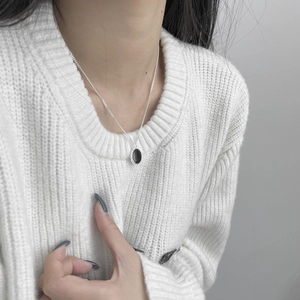 Collana in argento S925 con ciondolo ovale in smalto nero su maglione bianco