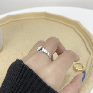 Close-up of minimalist S925 sterling silver chain ring with flat circular face design