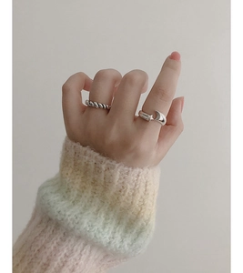 Close-up of S925 sterling silver braided ring and crescent star adjustable ring on model