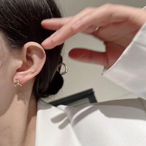 Cute golden bear stud earrings in S925 sterling silver worn by a model for a stylish look