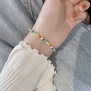 Colorful handmade beaded bracelet with S925 sterling silver beads for women on blue denim