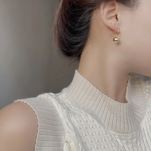 Minimalist 925 sterling silver gold ball drop earrings worn by a model on clean background