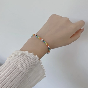 Detailed shot of rainbow beaded bracelet with silver accents on a woman's wrist