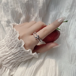Minimalist S925 sterling silver horseshoe ring worn on finger with a fresh strawberry