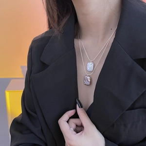 Close-up of double-layer S925 silver necklace with baroque pearl pendants on a model