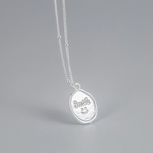 Minimalist S925 sterling silver necklace with engraved smile face oval pendant detail