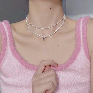 Close-up of double-layer necklace with freshwater pearls and sparkling silver chain