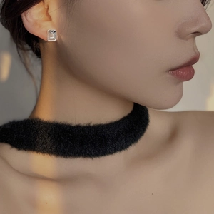 Close-up of minimalist geometric square stud earrings with clear faceted crystals