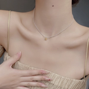 Minimalist 925 silver beaded choker with gold ring pendant on neck