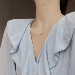 Detailed view of polished 925 sterling silver beads on a minimalist collar necklace