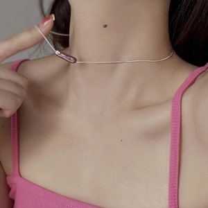 Close-up of minimalist S925 silver chain with elegant baroque pearl pendant on neck