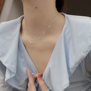 Detail of S925 sterling silver beaded necklace with multiple small rings on model