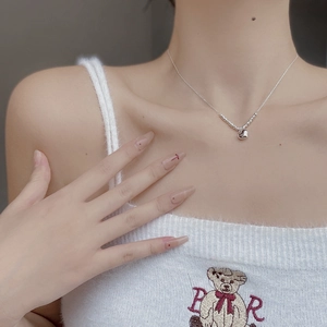 Gros plan d'un collier pendentif coeur en argent sterling 925 sur un mannequin