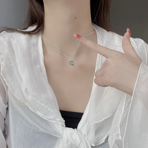 Minimalist S925 sterling silver smile necklace with oval pendant worn by a model