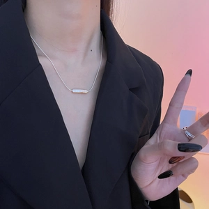 Close-up of S925 sterling silver snake chain with rectangular pearl pendant on model