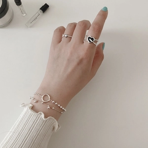 S925 sterling silver layered cross ring with black enamel heart charm on model