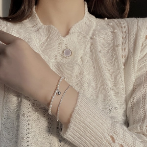 Detail of double-layer S925 silver bracelet with freshwater pearls and zircon accents