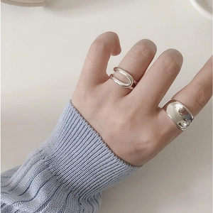 Minimalist S925 sterling silver hollow open rings worn by a model in a cozy blue sweater