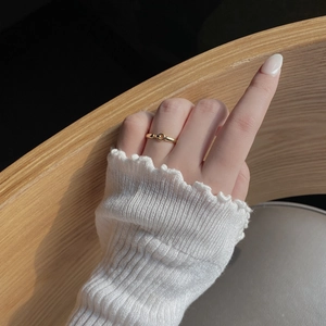 Minimalist 18K gold plated 925 sterling silver knotted ring on a model's finger