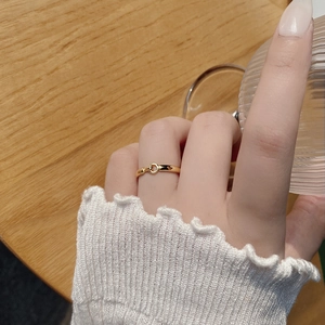 French style polished gold interlocking link ring shown in a lifestyle scene