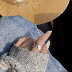 Macro shot of 925 sterling silver V-shape ring with irregular crushed foil texture