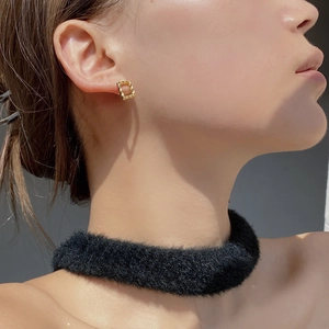 Detail of square gold twisted earrings showing elegant geometric S925 sterling silver design