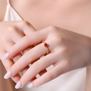 Elegant S925 silver gold-plated ring with red garnet and diamond accents on hand