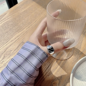 Dettaglio anello minimalista in argento S925 con intarsio rettangolare nero sulla mano del modello