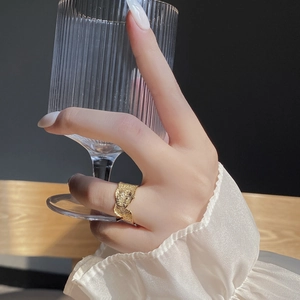 Detailed view of the gold irregular foil texture ring with minimalist V-shaped design