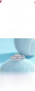 Detailed shot of Moissanite flower ring in 925 silver placed on a textured blue tennis ball