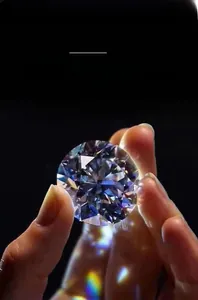 Macro shot of a high quality round brilliant cut moissanite diamond showing rainbow fire effects