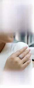 Close-up of a 925 sterling silver moissanite ring featuring a classic halo design