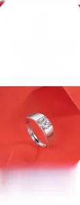 Detail of moissanite silver ring with four-prong setting on a red artistic background