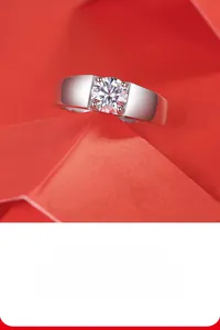 Macro shot of polished silver moissanite ring on a geometric red artistic paper stand