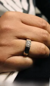 Close-up of a four-prong Moissanite diamond ring in S925 sterling silver on finger