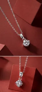 Detailed view of round brilliant cut moissanite pendant with silver four-prong setting